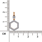 A gold and silver-toned hexagonal pendant with a clear round gemstone, shown next to a centimeter ruler for scale on a white background.