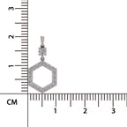 A silver-toned hexagonal pendant with a bezel-set diamond cluster at the bail, shown next to a black ruler with centimeter markings on a white background.