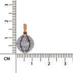 A yellow gold oval pendant with a marquise-cut clear center stone and surrounding pavé-set clear stones, shown next to a centimeter ruler for scale on a white background.