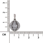A silver-toned oval pendant with a marquise-cut center stone and surrounding pavé accents, shown next to a centimeter ruler for scale on a white background.