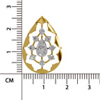 A gold teardrop-shaped pendant with a floral cutout design and a central diamond, shown next to a black ruler with centimeter markings to indicate its size.
