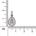 A silver teardrop pendant with a halo and central round gemstone, shown next to a centimeter ruler for scale on a white background.