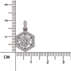 A silver-toned hexagonal pendant with a central round diamond and surrounding pavé-set diamonds, shown next to a centimeter ruler for scale on a white background.