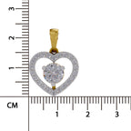 A heart-shaped pendant with a gold bail, featuring a central round clear gemstone surrounded by a double-heart outline paved with small clear stones, shown next to a centimeter ruler for scale.