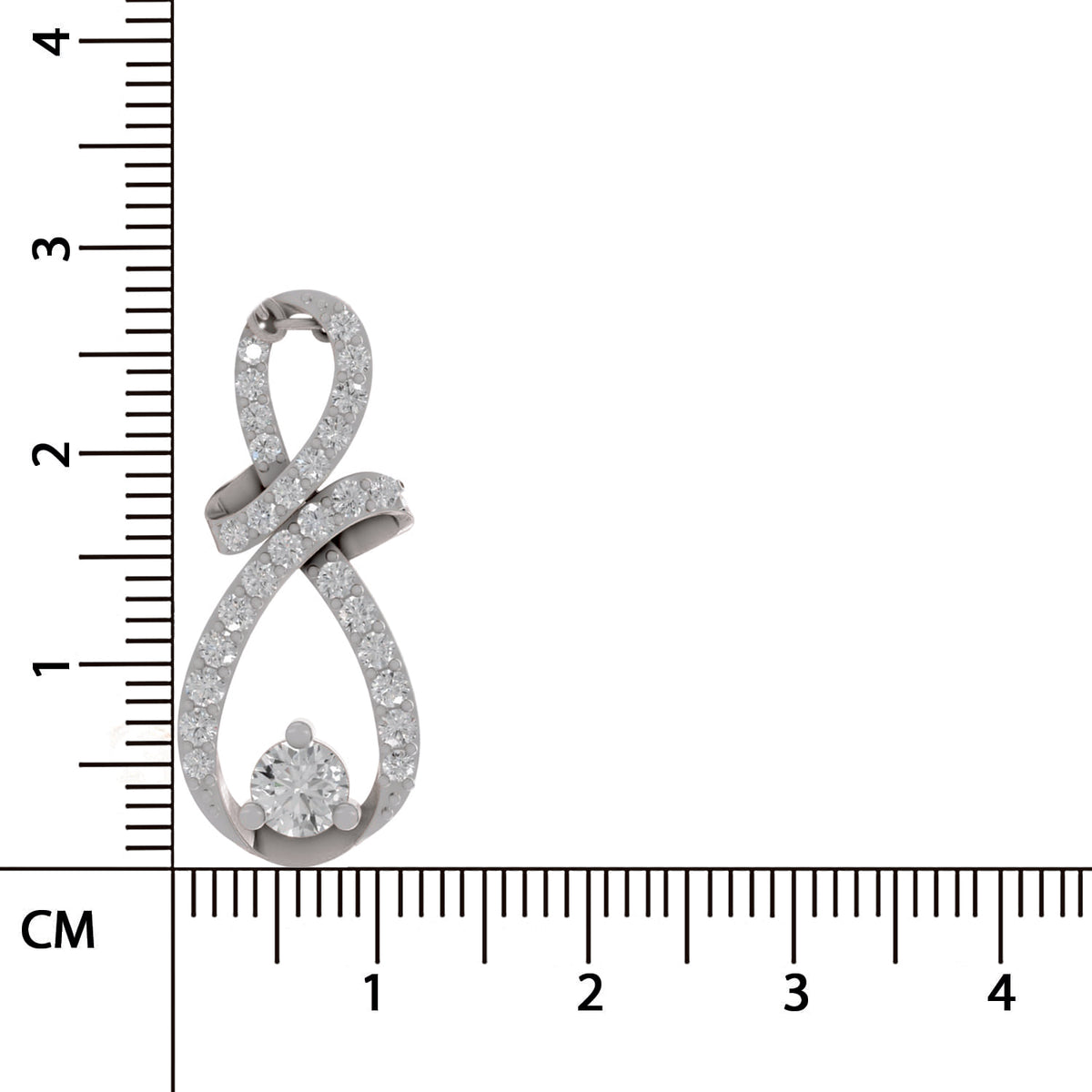 A silver-toned infinity-shaped pendant with pavé-set clear stones and a round center stone, shown next to a centimeter ruler for scale on a white background.
