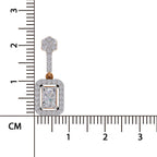 A rectangular diamond pendant with a gold and diamond halo, shown next to a centimeter ruler for scale on a white background.