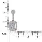 A rectangular emerald-cut diamond pendant with a halo setting and a floral-shaped bail, shown next to a centimeter ruler for scale on a white background.