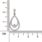 A silver teardrop-shaped pendant with a central heart-shaped clear gemstone, displayed next to a centimeter ruler to show its size.