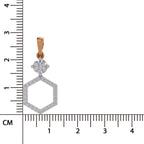 A close-up product photo of a pendant on a white background with a centimeter ruler on the left and bottom edges for scale. The pendant has a rose gold bail, a round clear gemstone, and a hexagonal openwork design set with small clear stones.