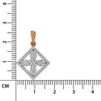 A diamond pendant in a rose gold cross or quatrefoil shape with a border of small diamonds, shown next to a centimeter ruler for scale on a white background.