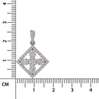 A diamond-shaped silver pendant with a four-petal floral design set with clear stones, shown next to a centimeter ruler for scale on a white background.