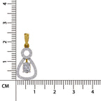 A gold and silver pendant with a clear teardrop-shaped gemstone, shown next to a black ruler in centimeters to indicate its size.
