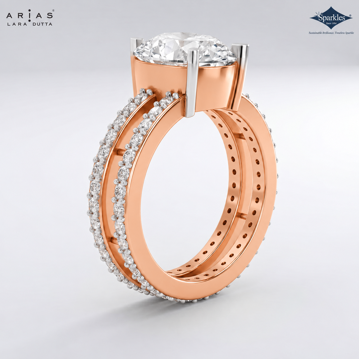 A rose gold engagement ring with a round brilliant-cut diamond center stone, shown alongside a matching rose gold wedding band paved with small diamonds. The brand logos 'Arias Lara Dutta' and 'Sparkle' are visible in the corners.