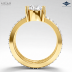A gold ring with a round-cut diamond center stone and a halo of small pavé-set diamonds along the band, shown from the back. The brand logos 'Ariás Lara Dutta' and 'Sparkle' are visible in the top corners.