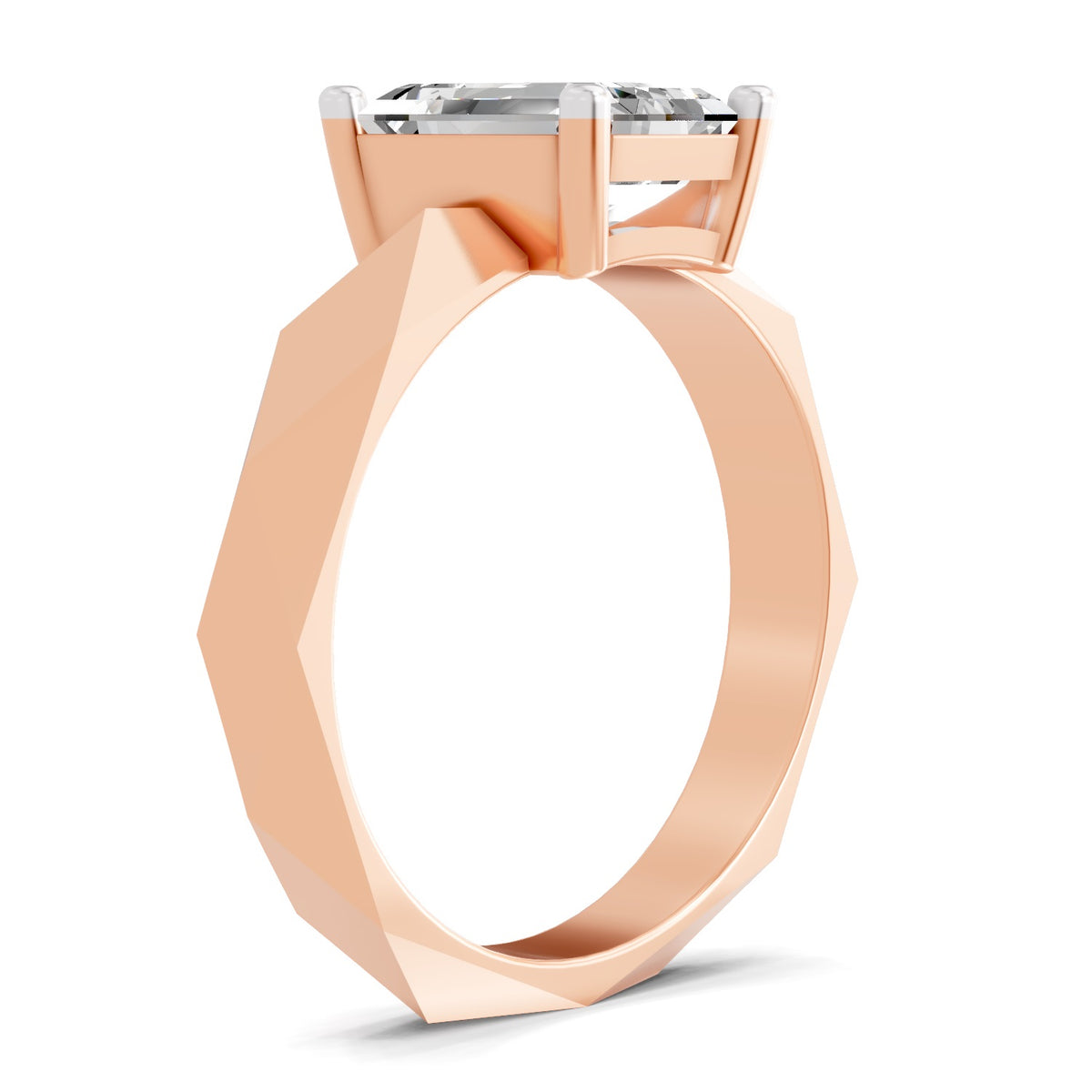 A rose gold ring with a faceted, geometric band and a clear rectangular gemstone in a four-prong setting, shown on a clean white background.