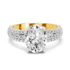 Top view of a yellow gold oval-cut 2.00 ct diamond engagement ring with a pavé diamond band