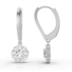A pair of silver leverback drop earrings, one shown from the front displaying a round halo cluster of clear gemstones and the other from the side showing the prong setting, on a white background.