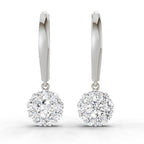 A pair of silver-toned hoop earrings with round halo-cut clear gemstones, shown on a clean white background.
